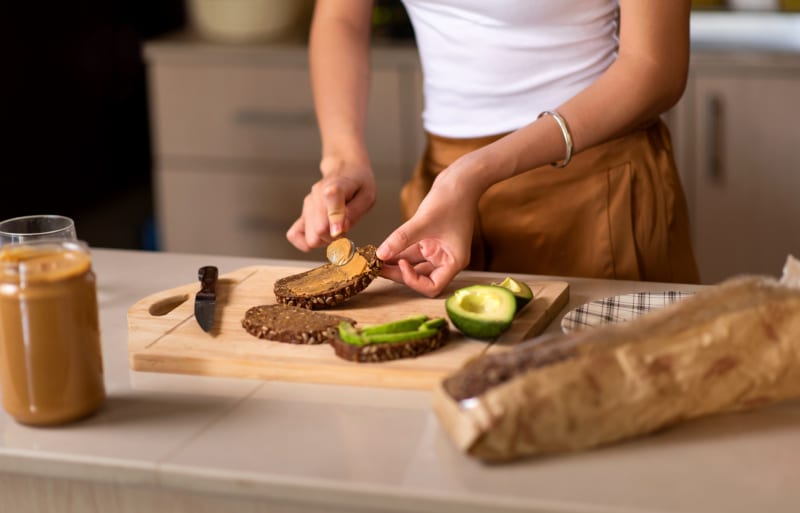 woman making a peanut butter sandwich